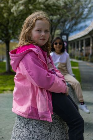 Two young girls posing in a park in Washington DC. Portrait taken by Chris Suits Photography