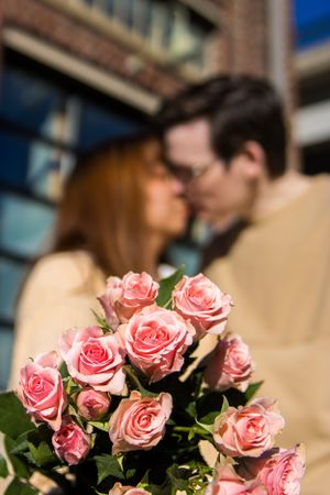 Couple kissing behind roses in Old Town Petersburg, portrait taken by Chris Suits Photography