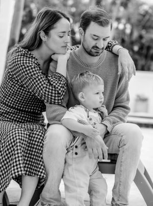 An intimate black and white family portrait showing a tender moment of togetherness.