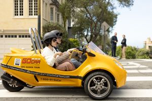two tourist ridding a small rented car to tour San Fransisco California