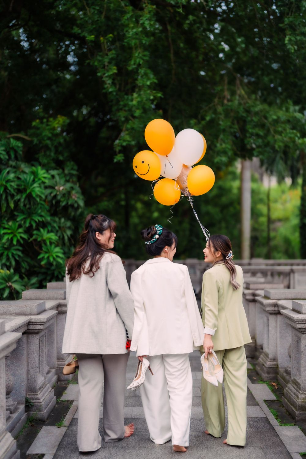 three friends with a flower ballon at Tatung University in Taipei City