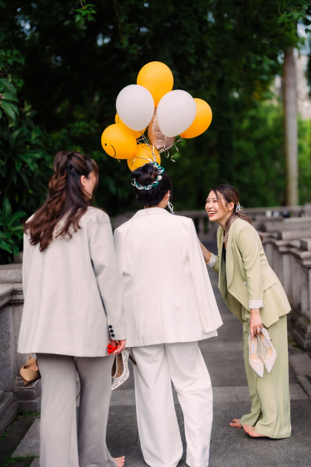 three friends with a flower ballon at Tatung University in Taipei City