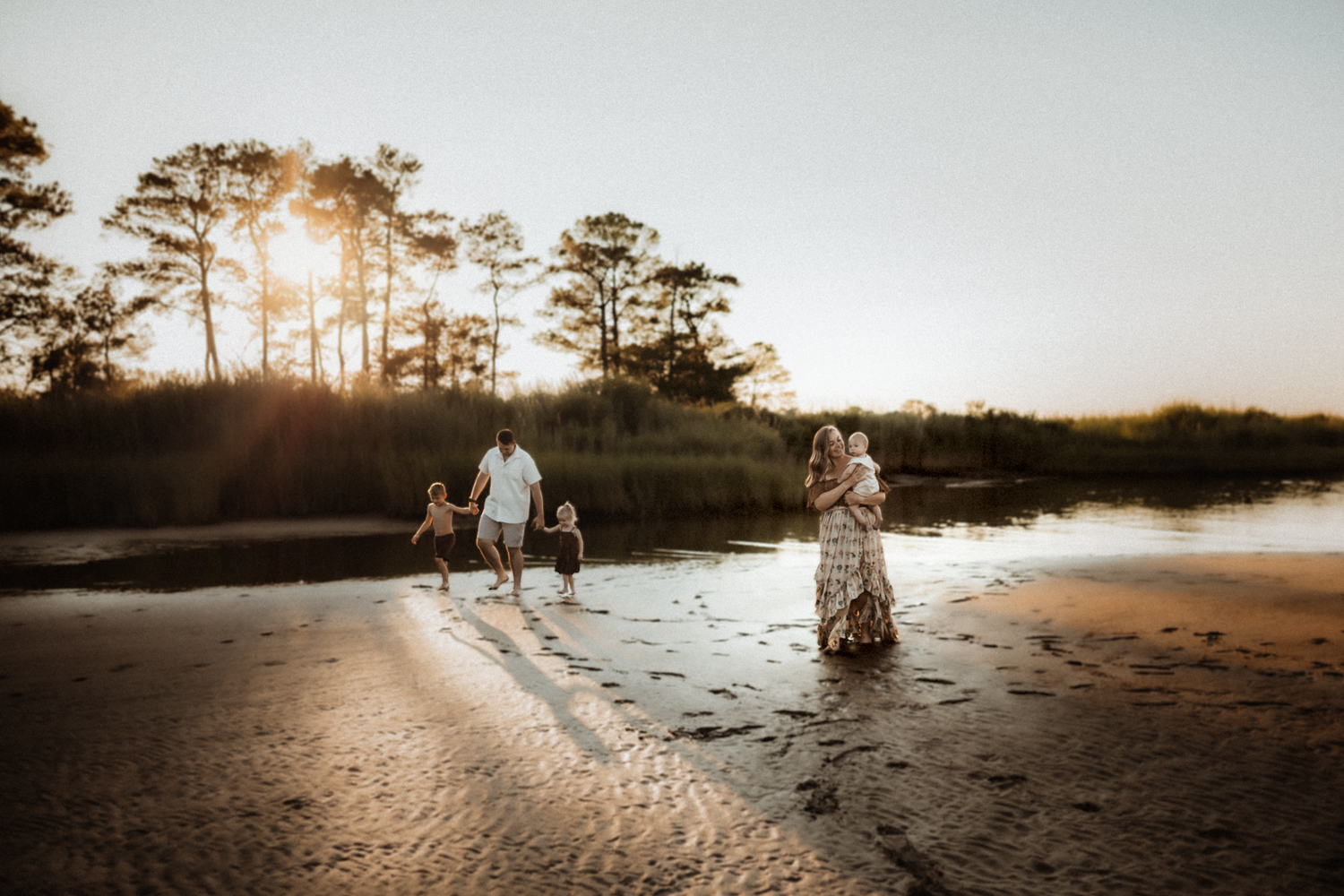 Playful outdoor family session with flowing fabric in sepia tones.
