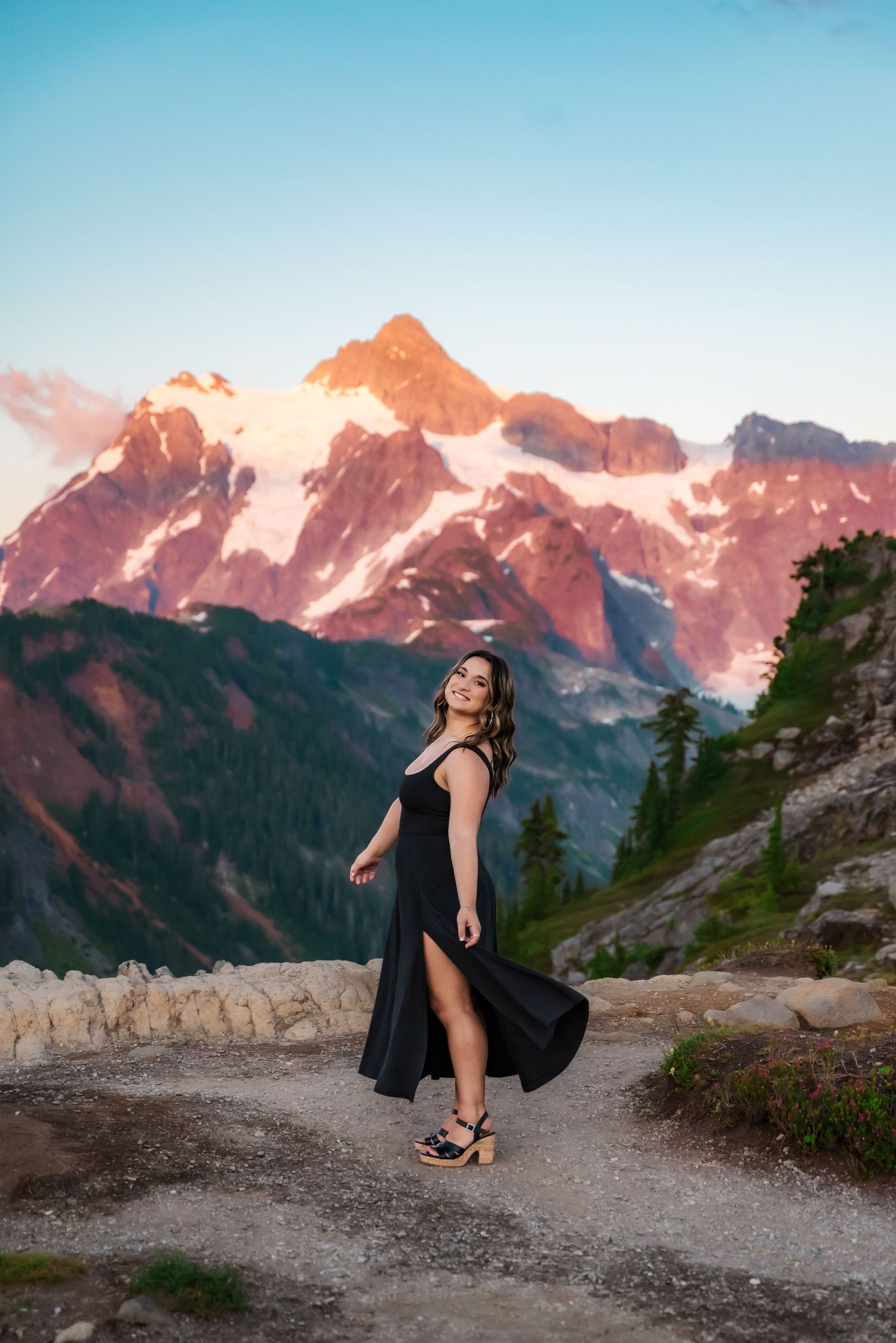 senior girl in black dress at sunset