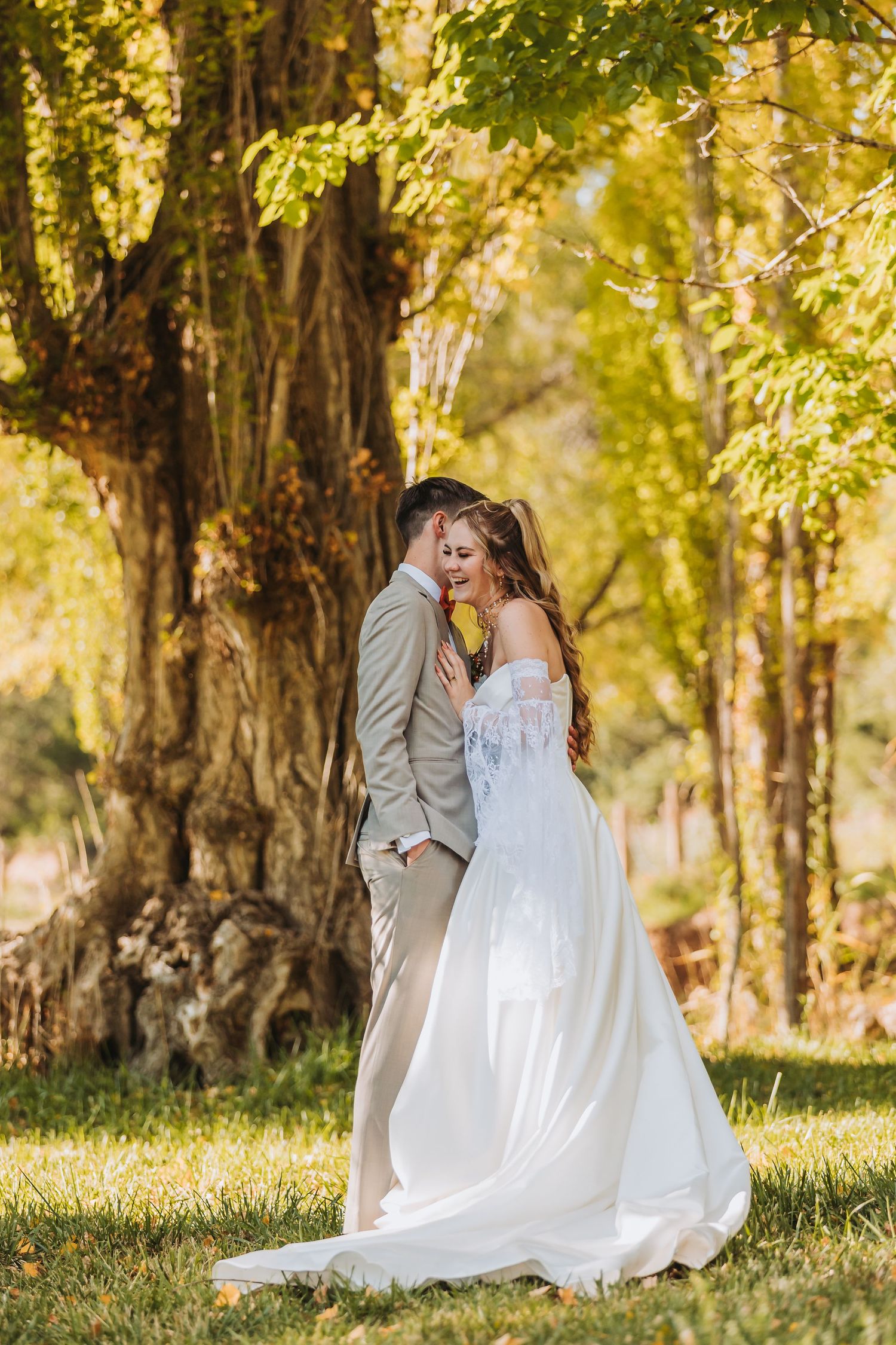 Intimate wedding portrait showing couple embracing in outdoor garden setting.
