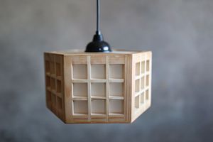 Minimalist hexagonal wooden pendant light fixture with grid pattern design.
