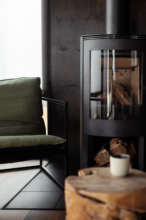 Cozy interior scene with dark furniture and a cup of coffee on wooden surface.