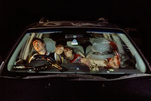 Car interior view at night with illuminated dashboard.