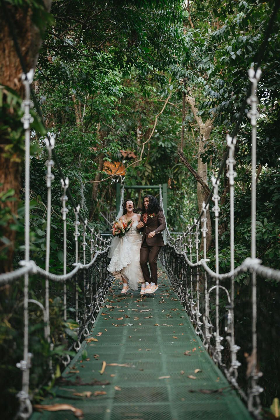 Couple standing on a rainforest bridge during a Costa Rica wedding shoot