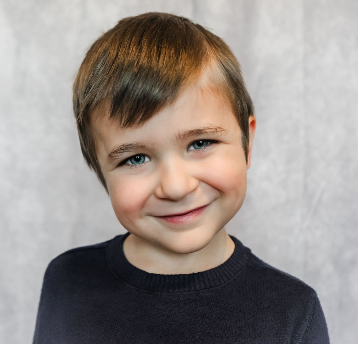 Studio Headshot Session in Tampa, FL; Young boy smiling into the camera