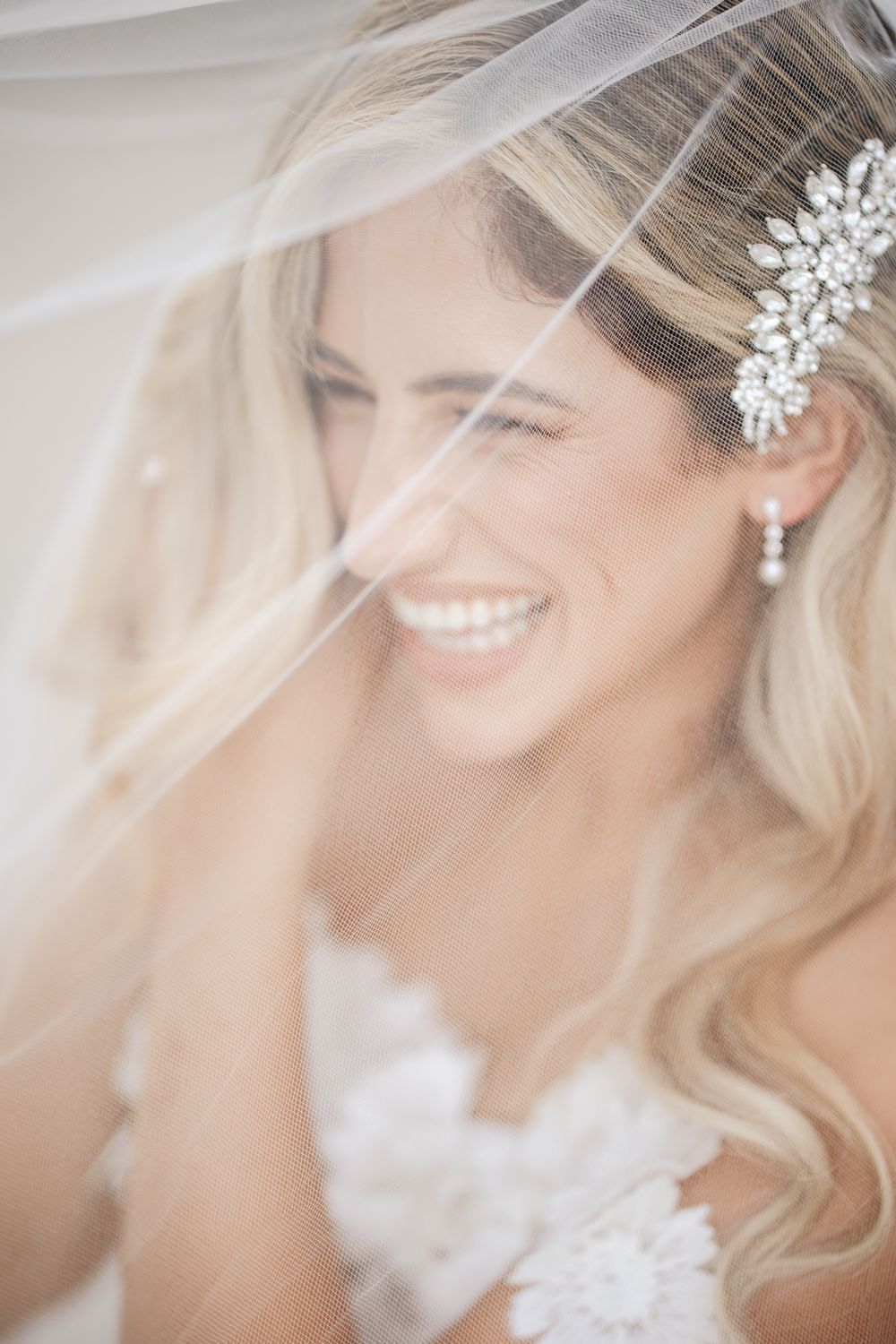 Ethereal bridal portrait series showing delicate veil details and crystal hair accessories in soft natural light.