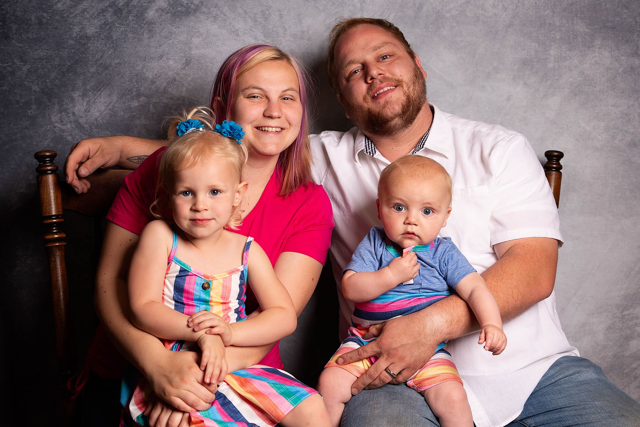 Family pose in front of backdrop