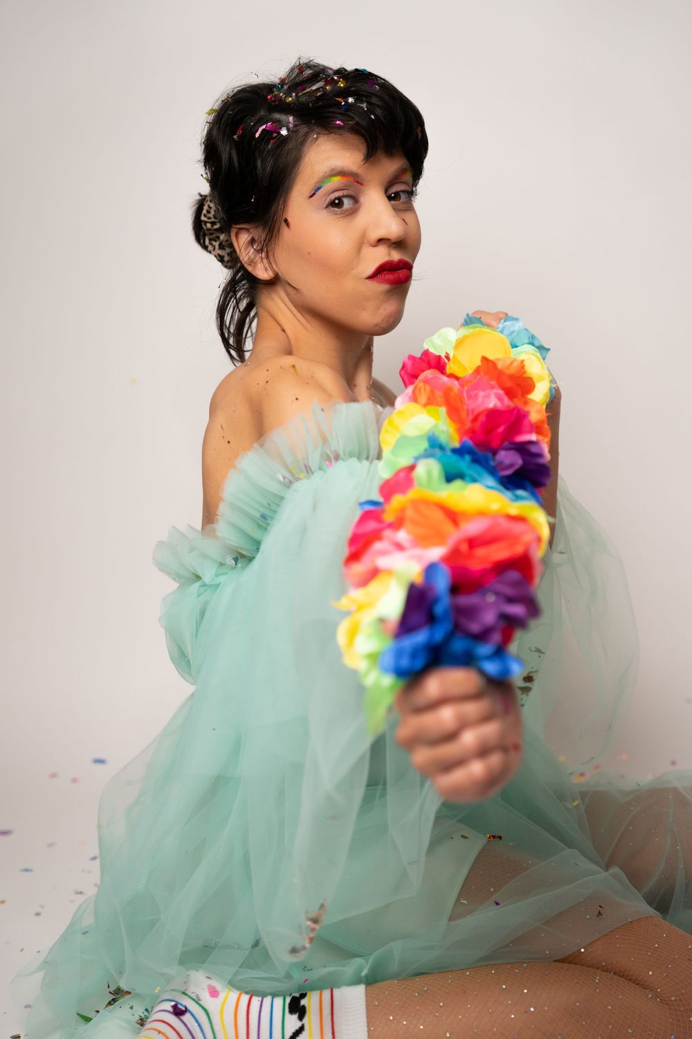 Elegant poses with rainbow decorations in ethereal mint green tulle gown.