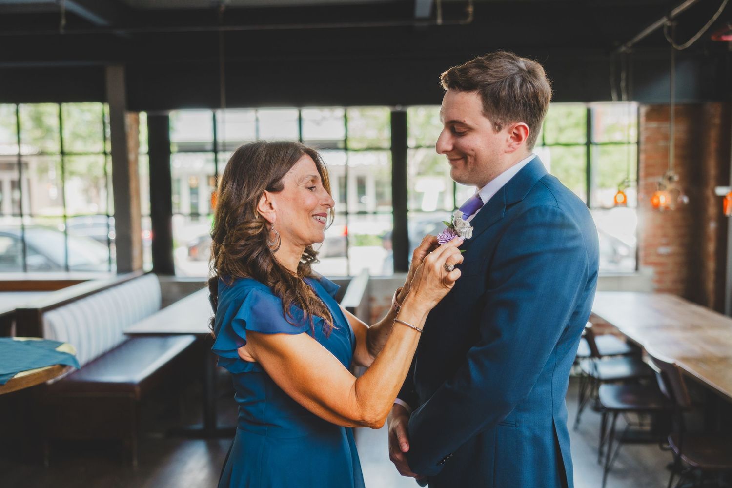 Couple shares an intimate moment in an industrial-style venue during their first dance.