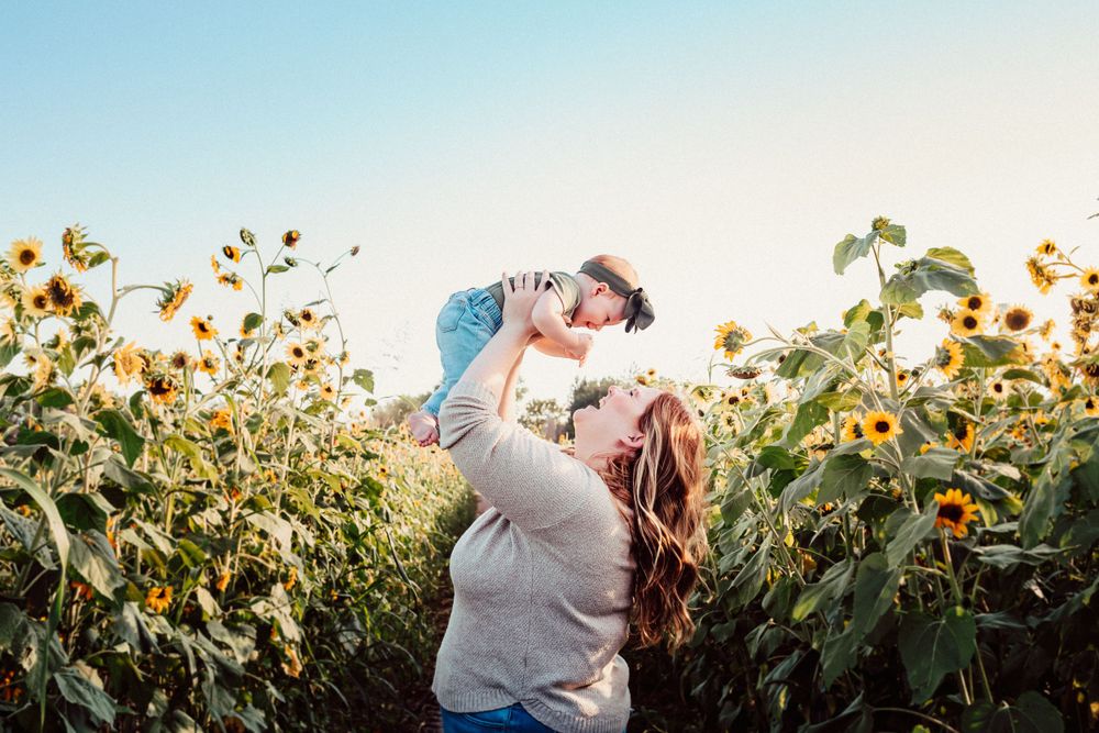 Joyful moment in a sunflower field during golden hour.