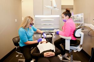 Dental examination taking place in modern clinic setting.