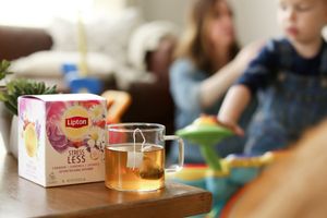 Tea cup and box on table with soft focus background interior.