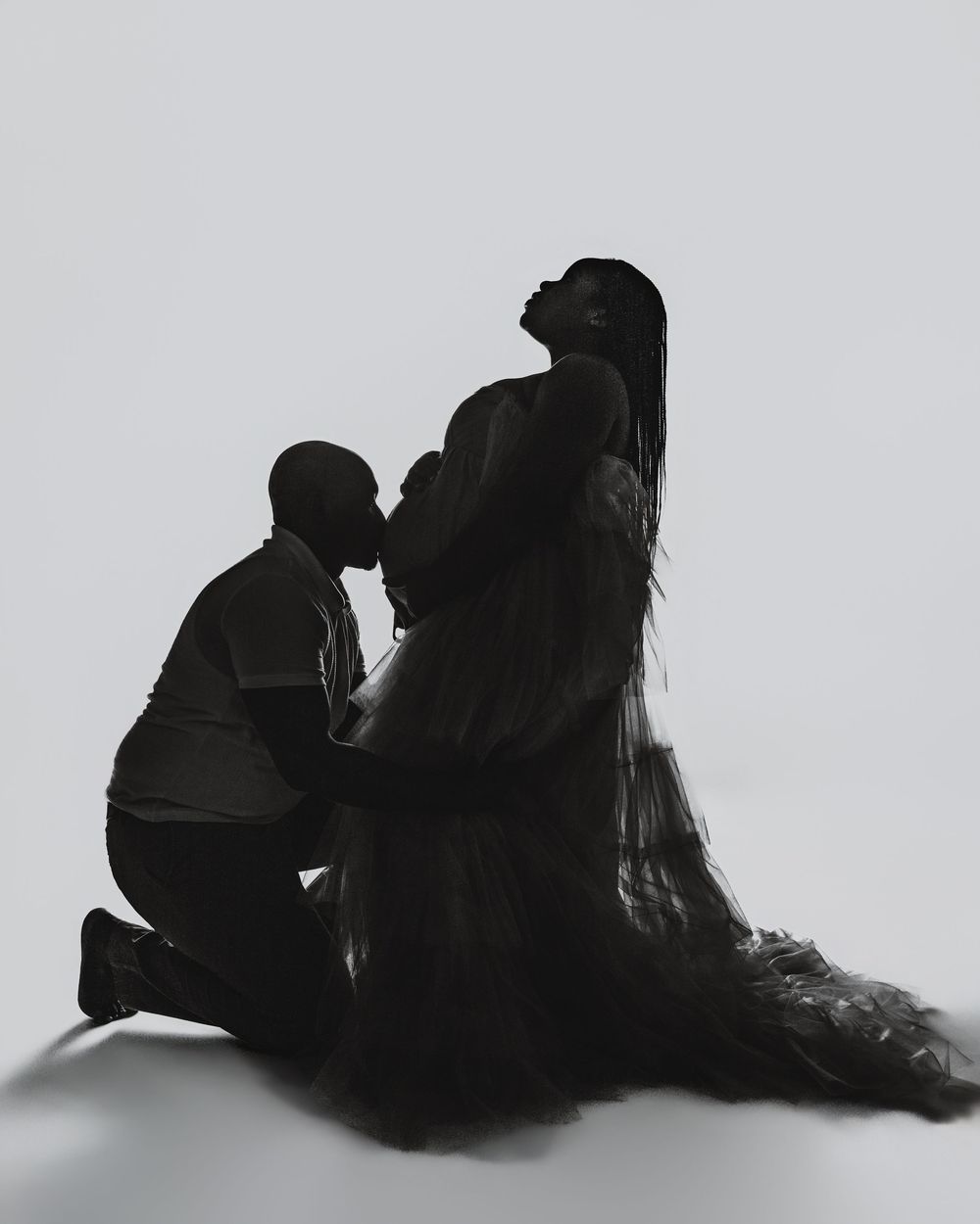 A series of silhouetted figures in an emotional sequence showing intimacy and connection against a light background.