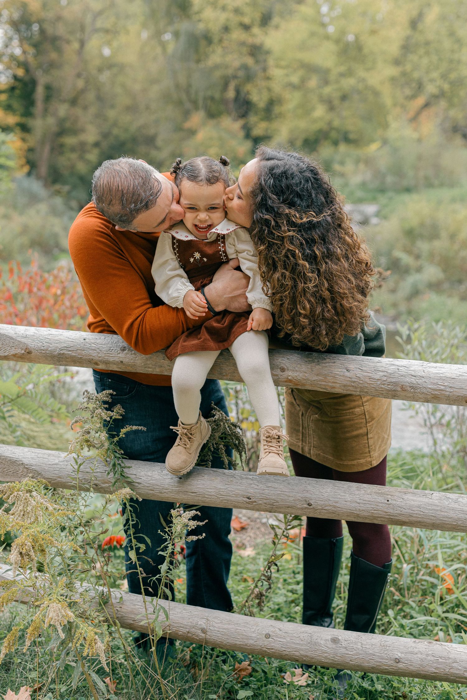 Couple sharing joyful moments together on a hardwood floor in a bright, sunlit room.