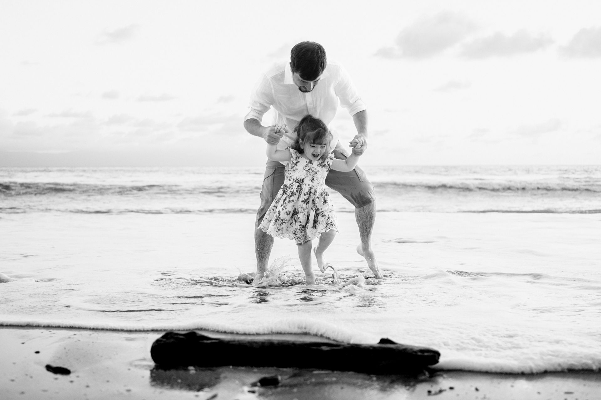 Playful family photos unfold along the shoreline as a Sayulita Family Photographer captures a relaxed beach family photo session.
