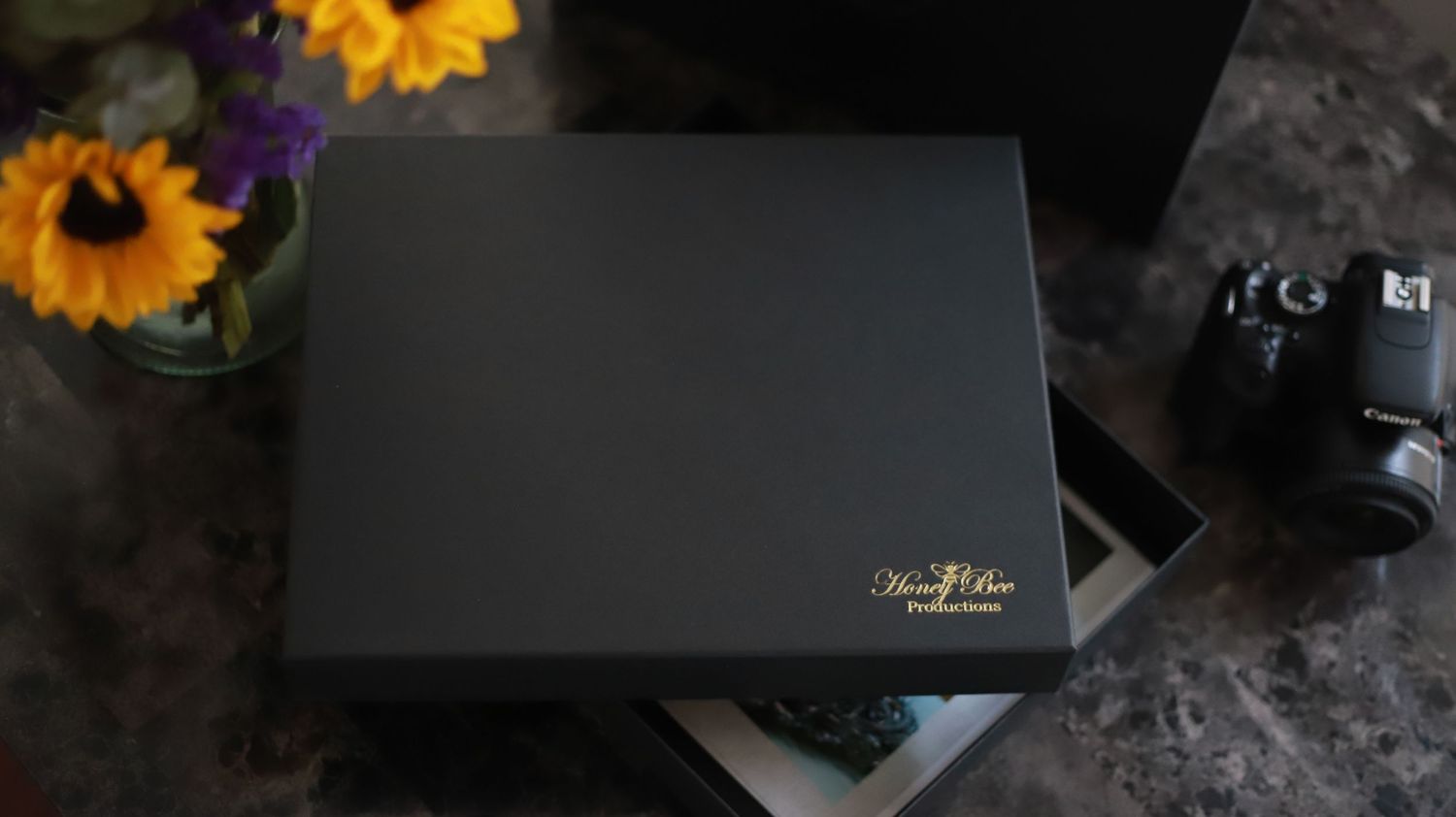 Photo of a black keepsake box containing printed photos.
