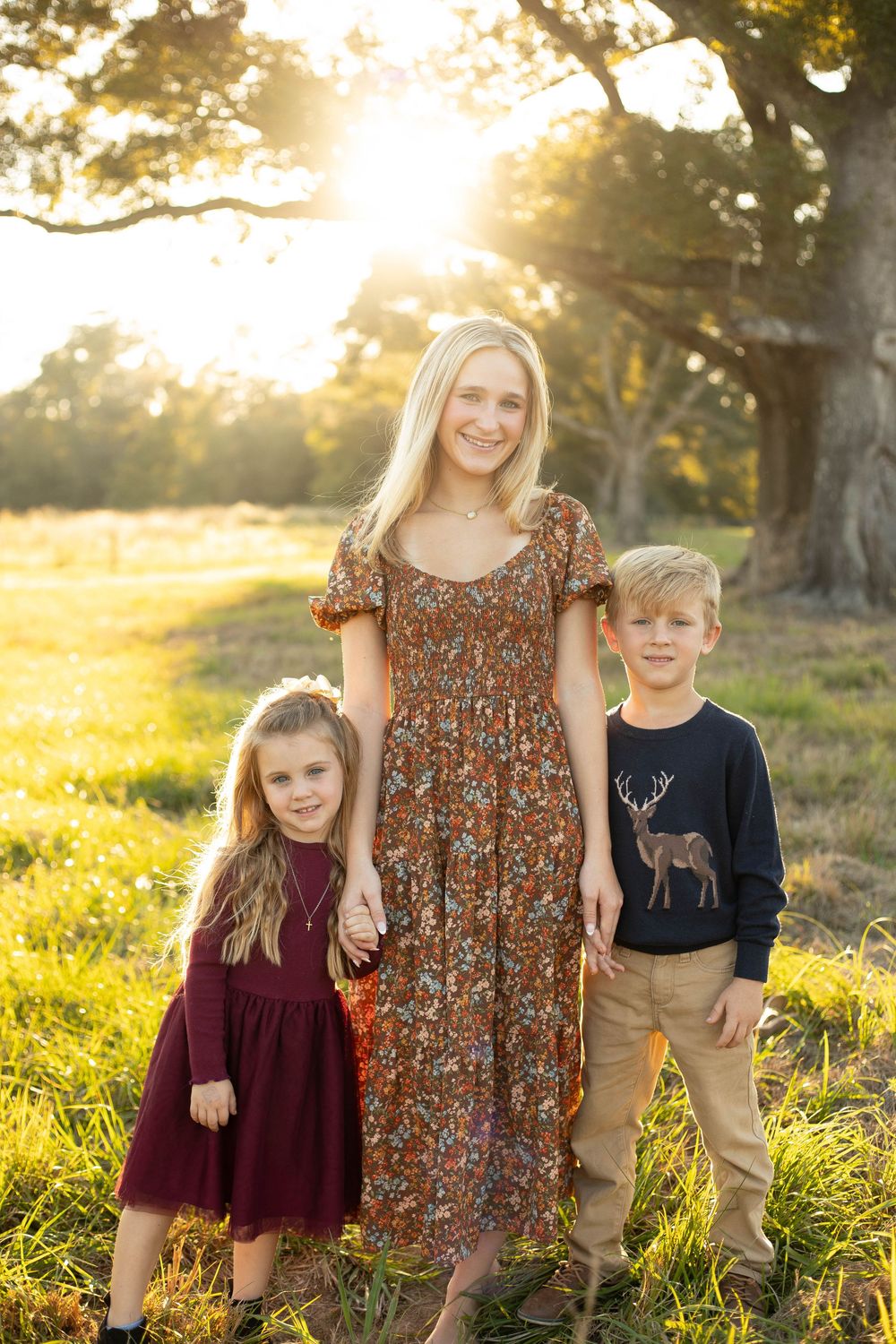 Siblings smiling together during a family photography session in East Baton Rouge Parish.