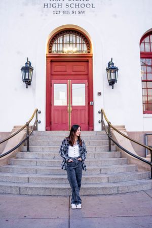 High school entrance with red door and lanterns showing casual street style.