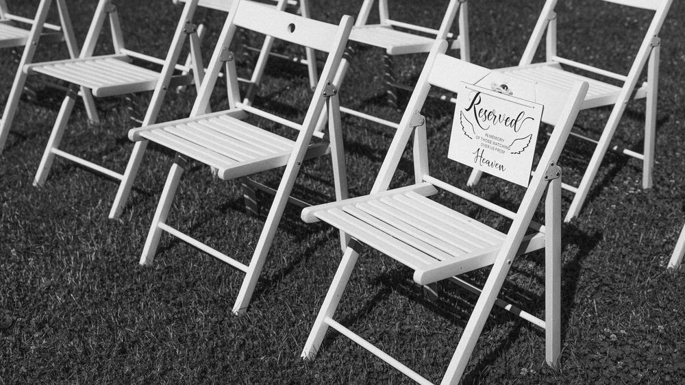 black and white photo of a chair reserved for passed mother
