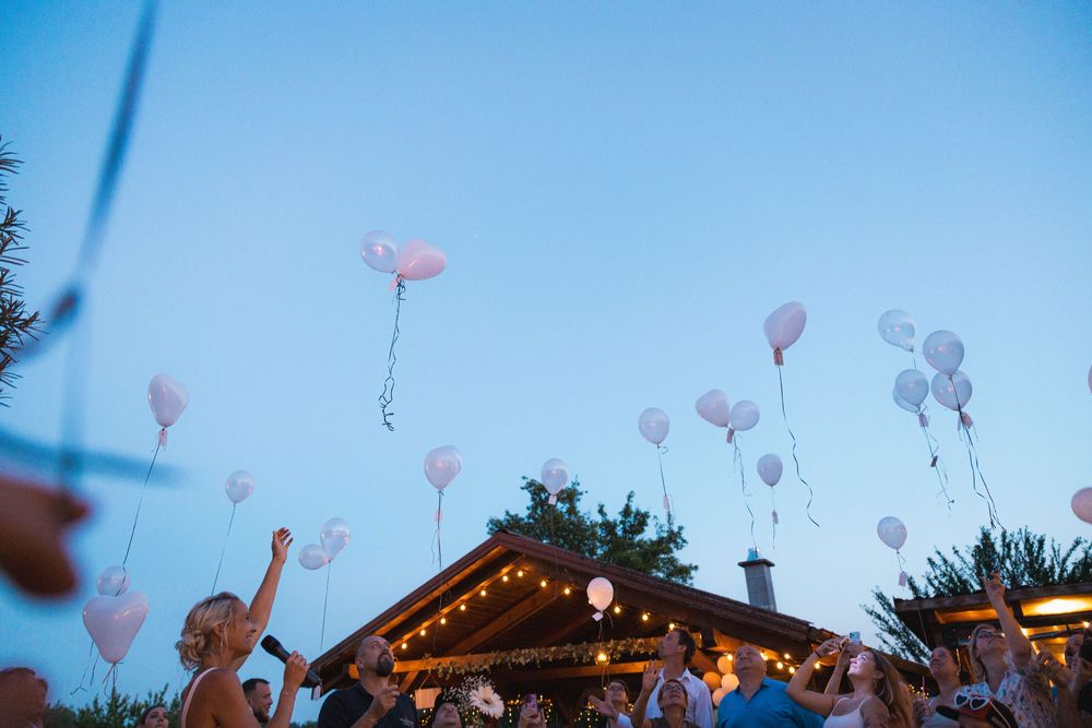 helium balloons with hand written wishes flying away