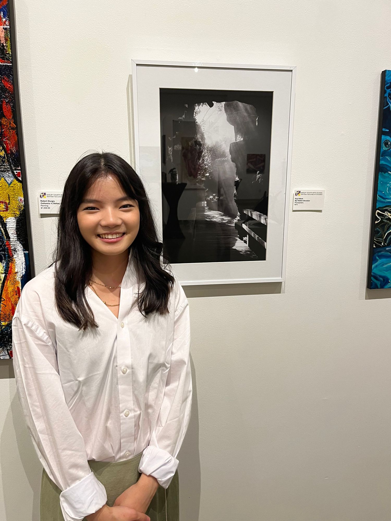 Kayli Meek at art exhibition at the Shelby Country Arts Council.