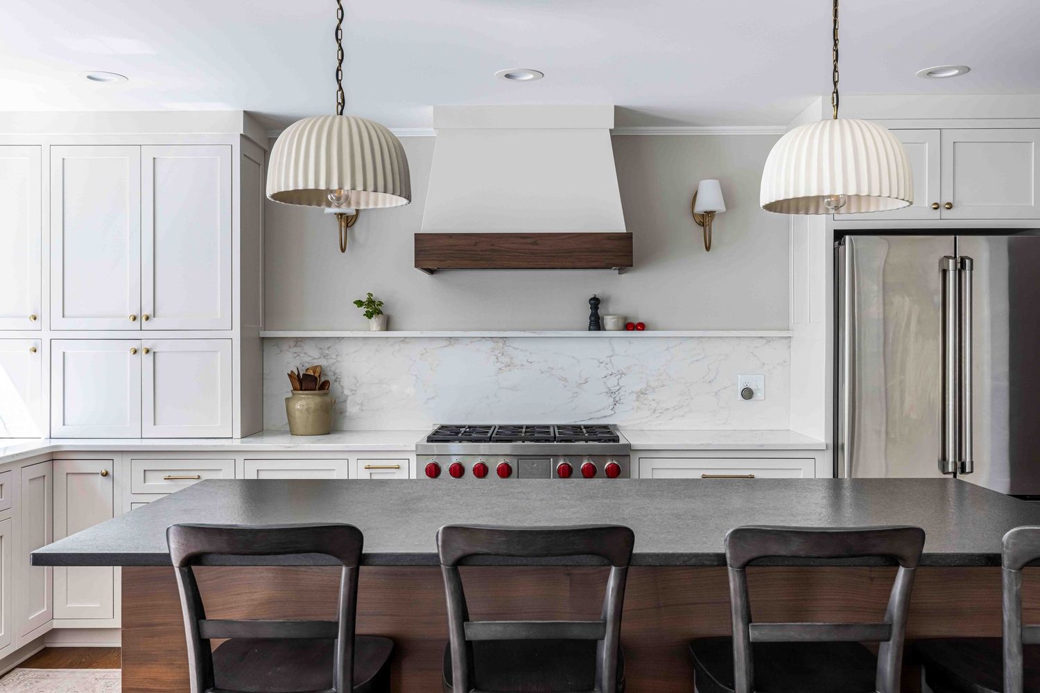 A minimalist kitchen with beautiful wooden accents and marble backsplash, with lots of soft natural light.
