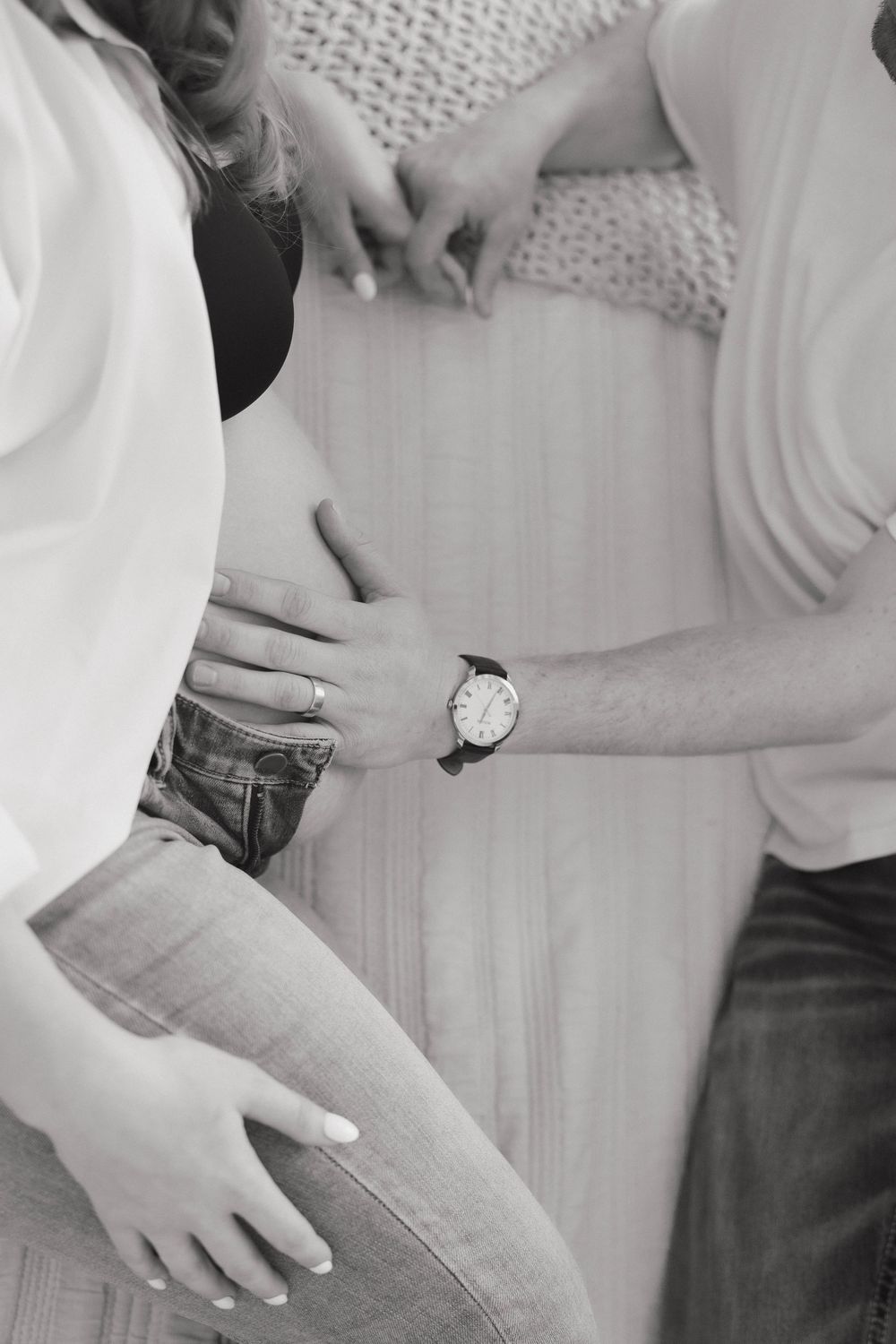 Close-up shots showing gentle hand touches and embraces between two people in white and denim.