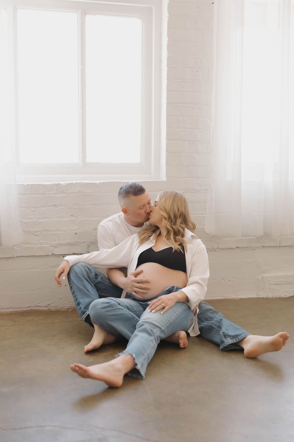 A sequence of intimate moments captured in a bright white studio space with natural light streaming through windows.
