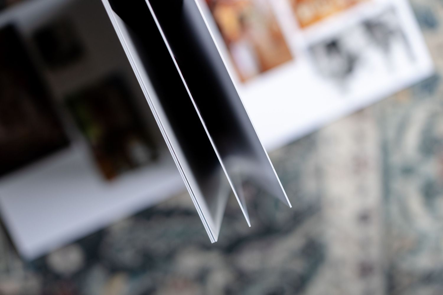 Close-up view of an opened wedding photo album with fanned pages showing memories.