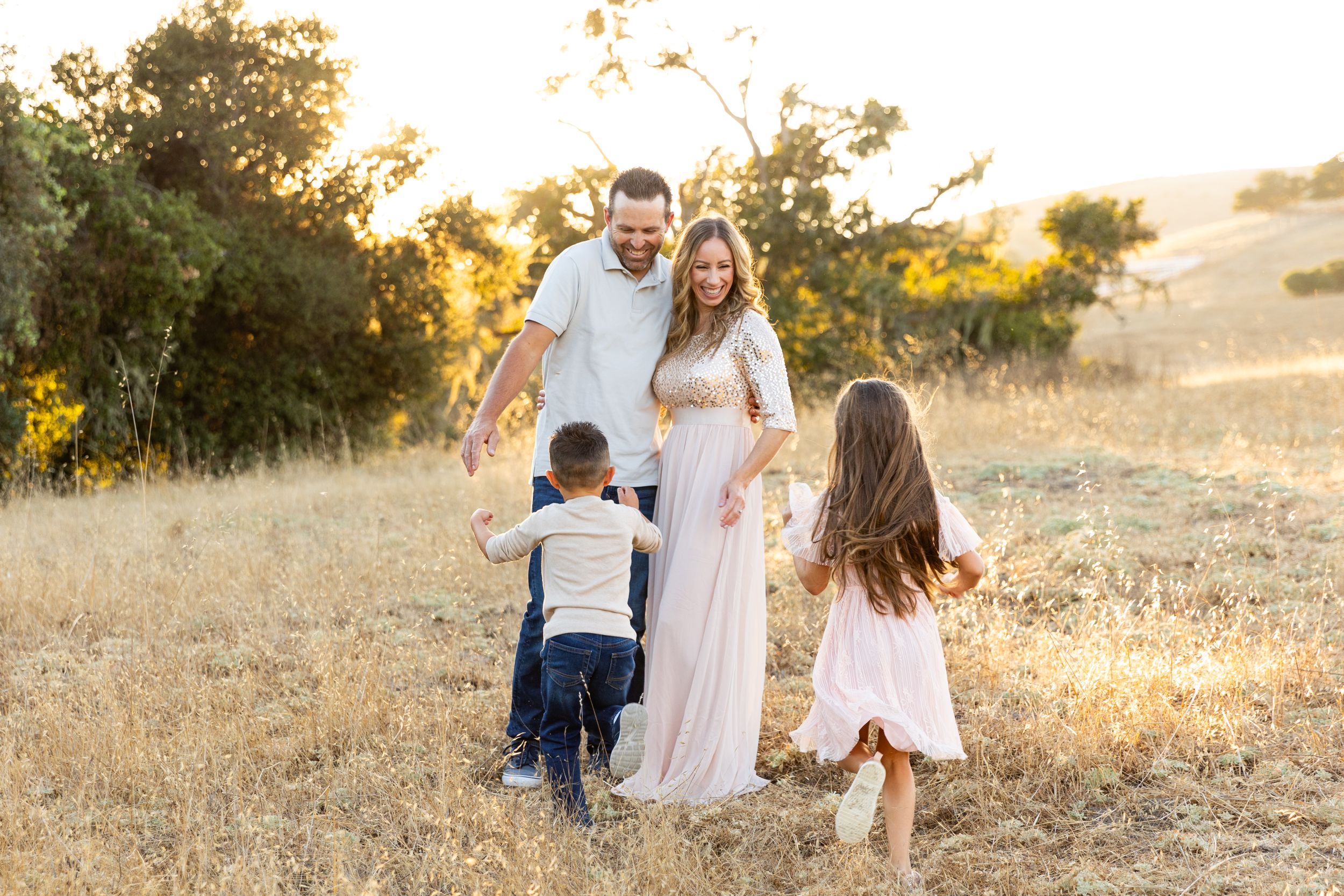Family walking together at sunset during a lifestyle photo session outdoors in Monterey, California with Rachel Zee Photography.