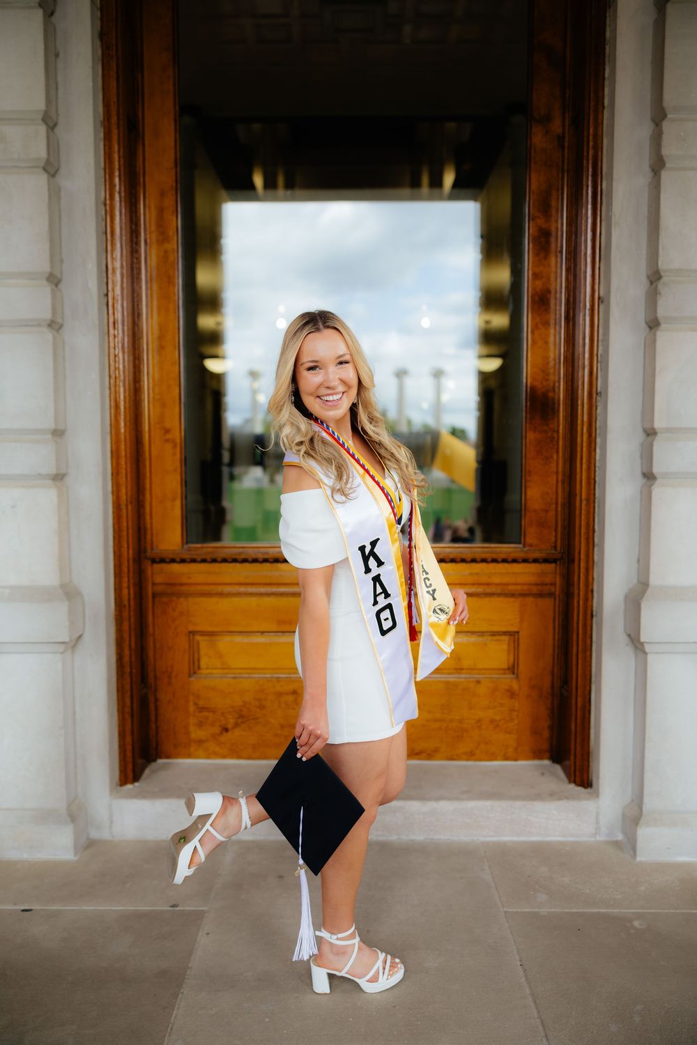 Graduation photo series showing celebratory poses on building porch.