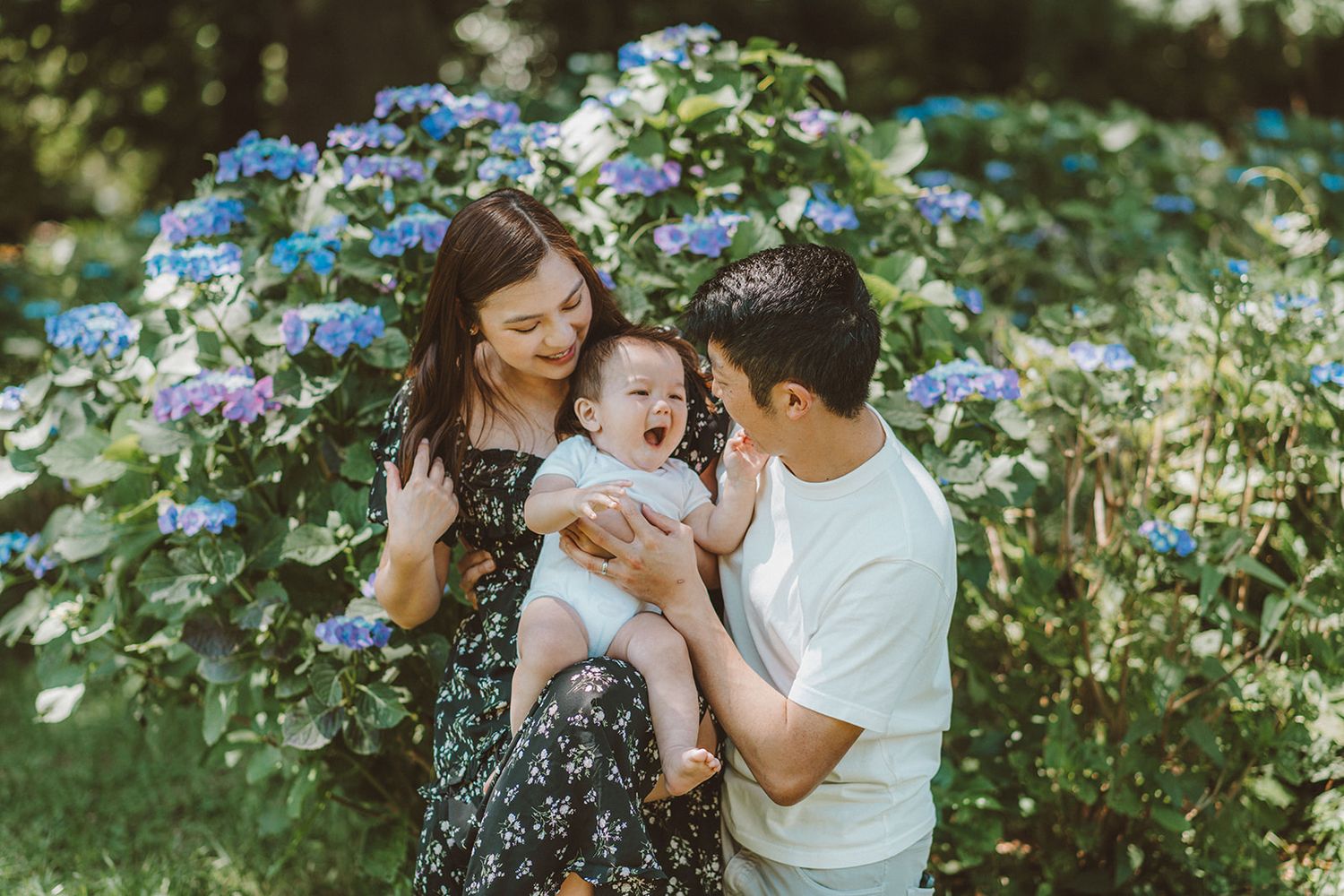 Capturing a family of three with baby in a park for a family portrait session