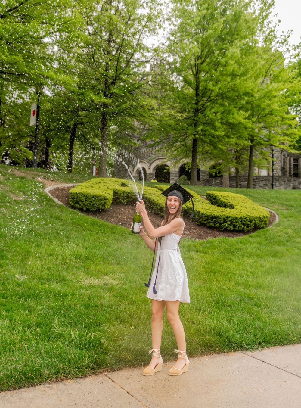 girl popping champagne grad photo Arcadia