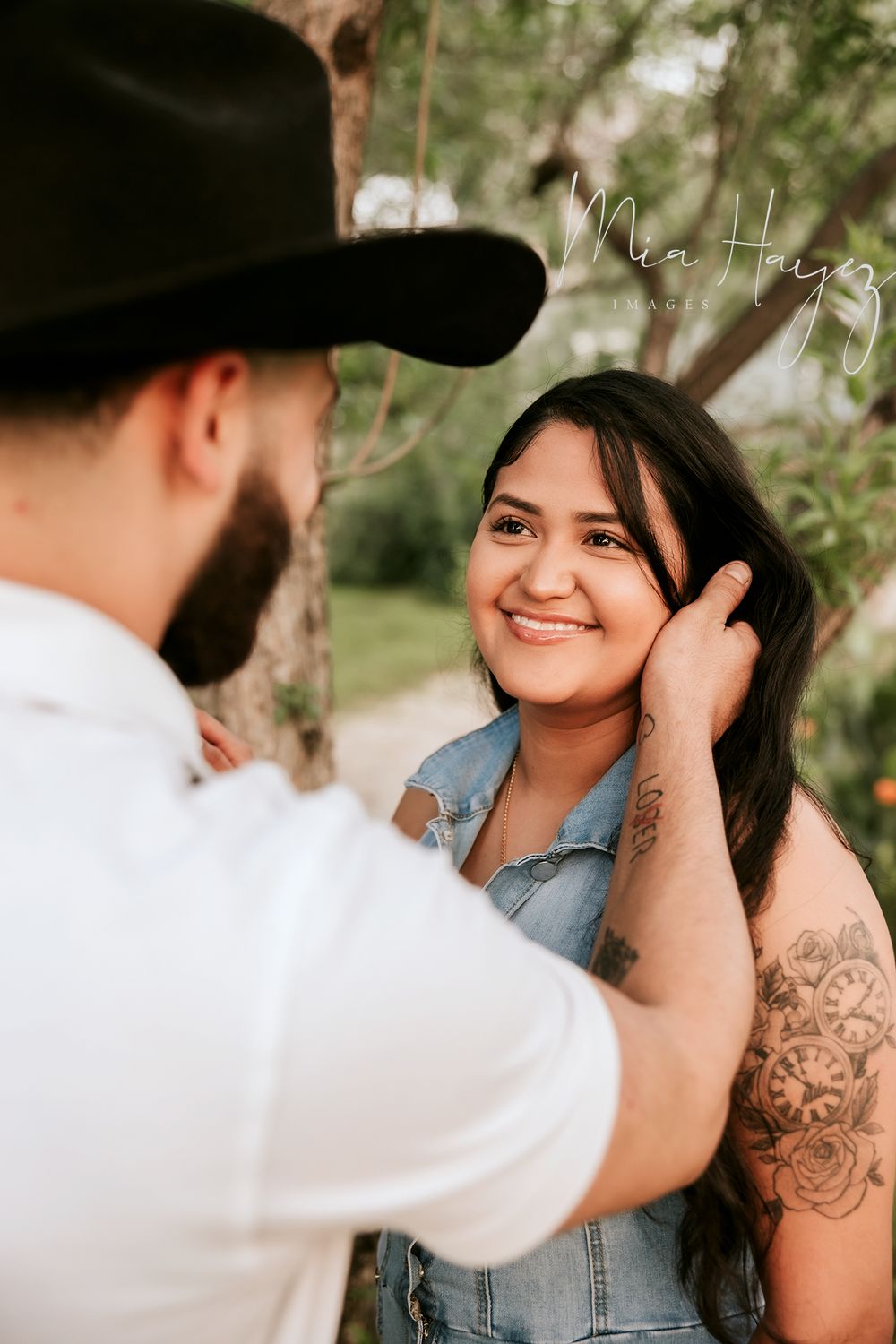 Intimate couple portraits captured outdoors showing affectionate moments and genuine smiles.