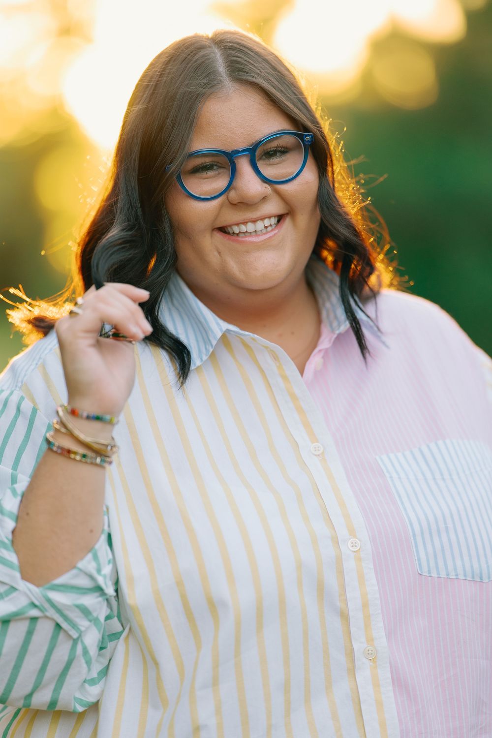 Close-up portraits showing striped clothing and blue glasses in warm sunlight.