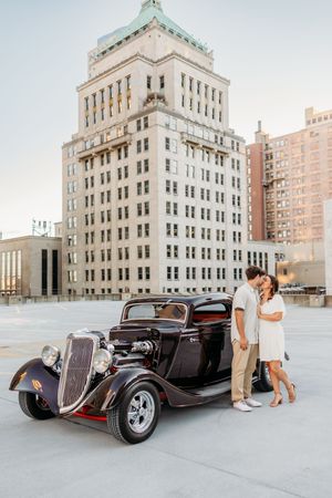 Engagement photos on top of a roof downtown with a classic car. Cincinnati Wedding photographer. NKY wedding photographer. Chicago Wedding.