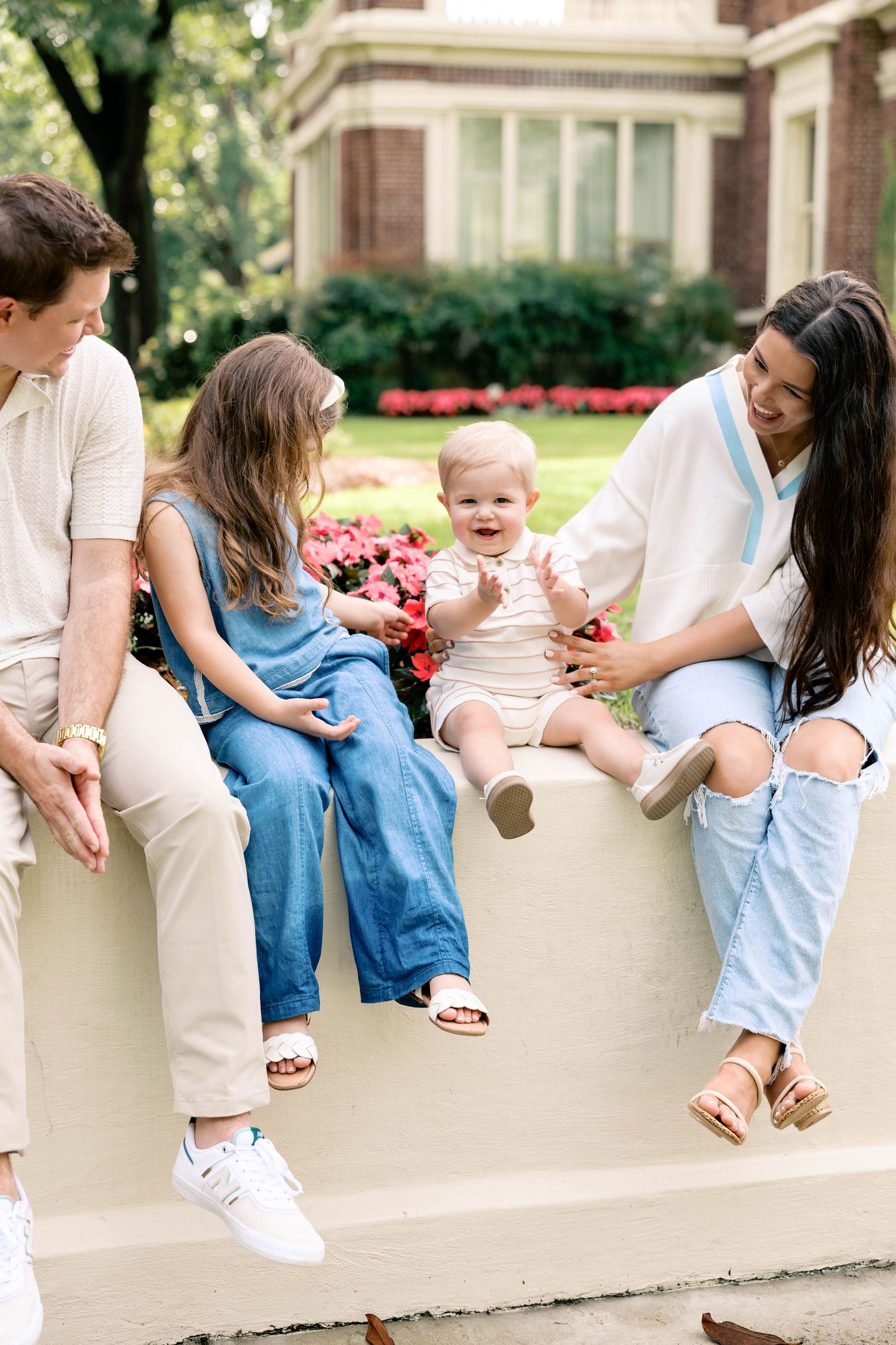 A couple shares romantic moments in a field during maternity photoshoot.