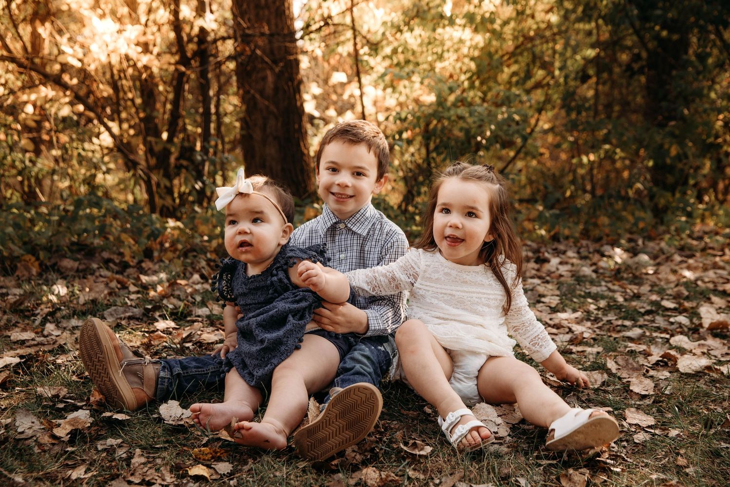 Photography - Siblings in a wooded area during fall.