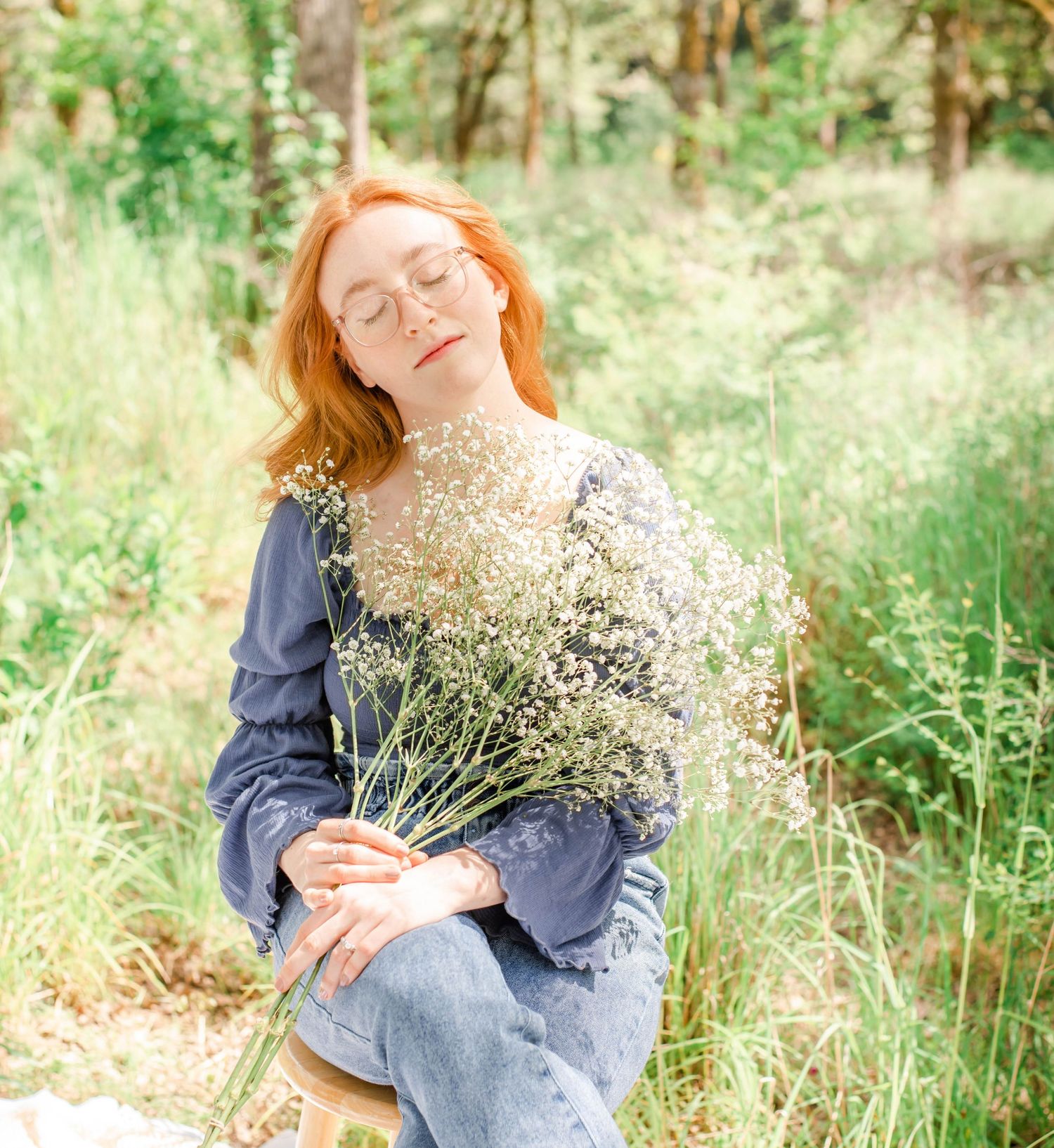 Whimsical outdoor photo with wildflowers against natural forest backdrop.