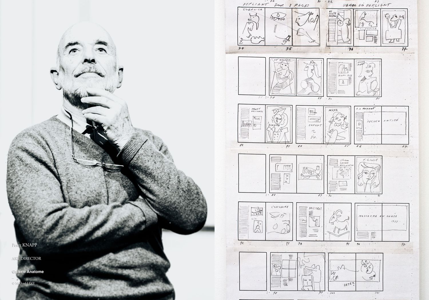 Black and white photo of a man in a sweater beside storyboard sketches pinned to a wall.