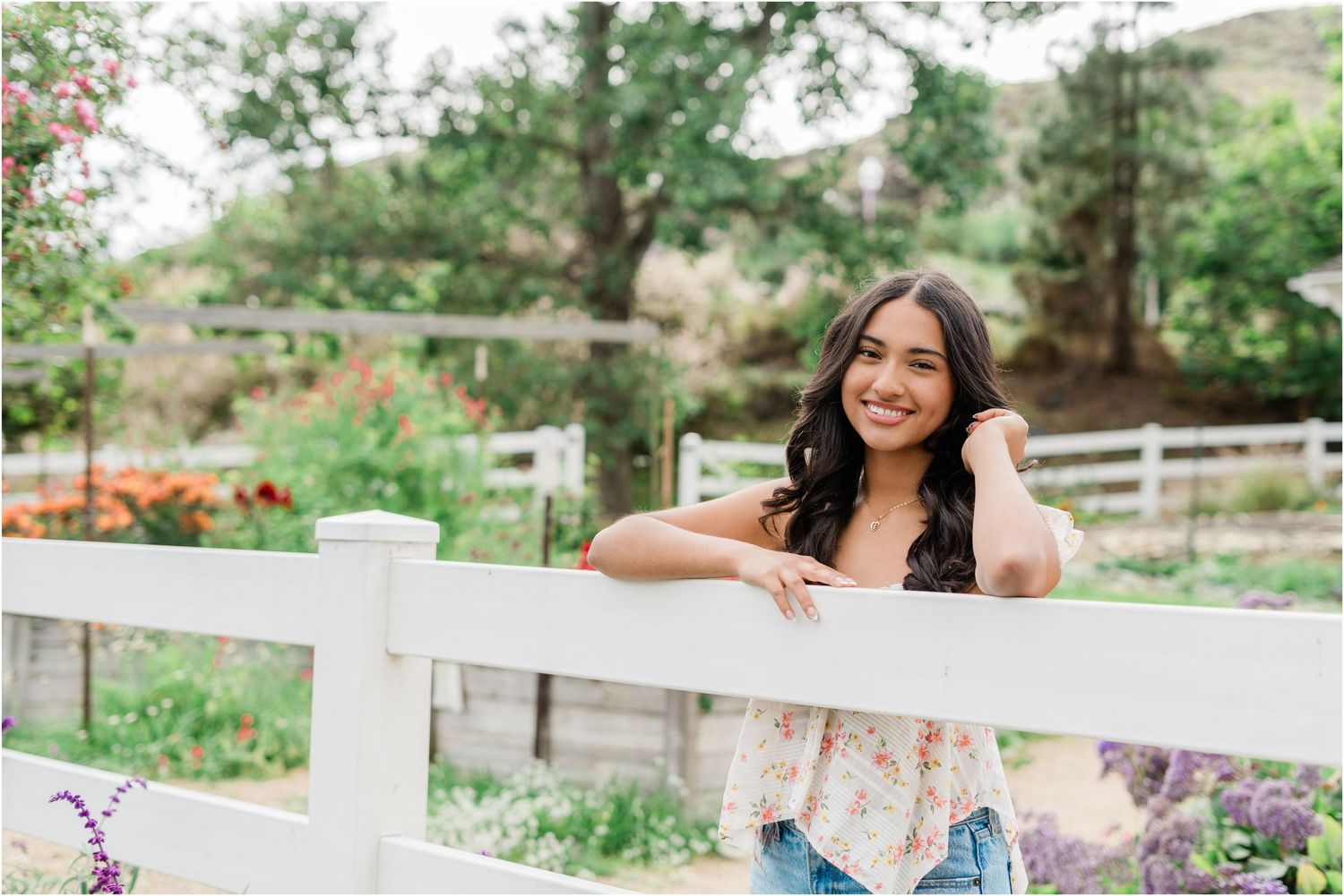 SLO senior photographer capturing natural senior photos at Madonna Inn Gardens with gardens, jeans, and classic senior style.