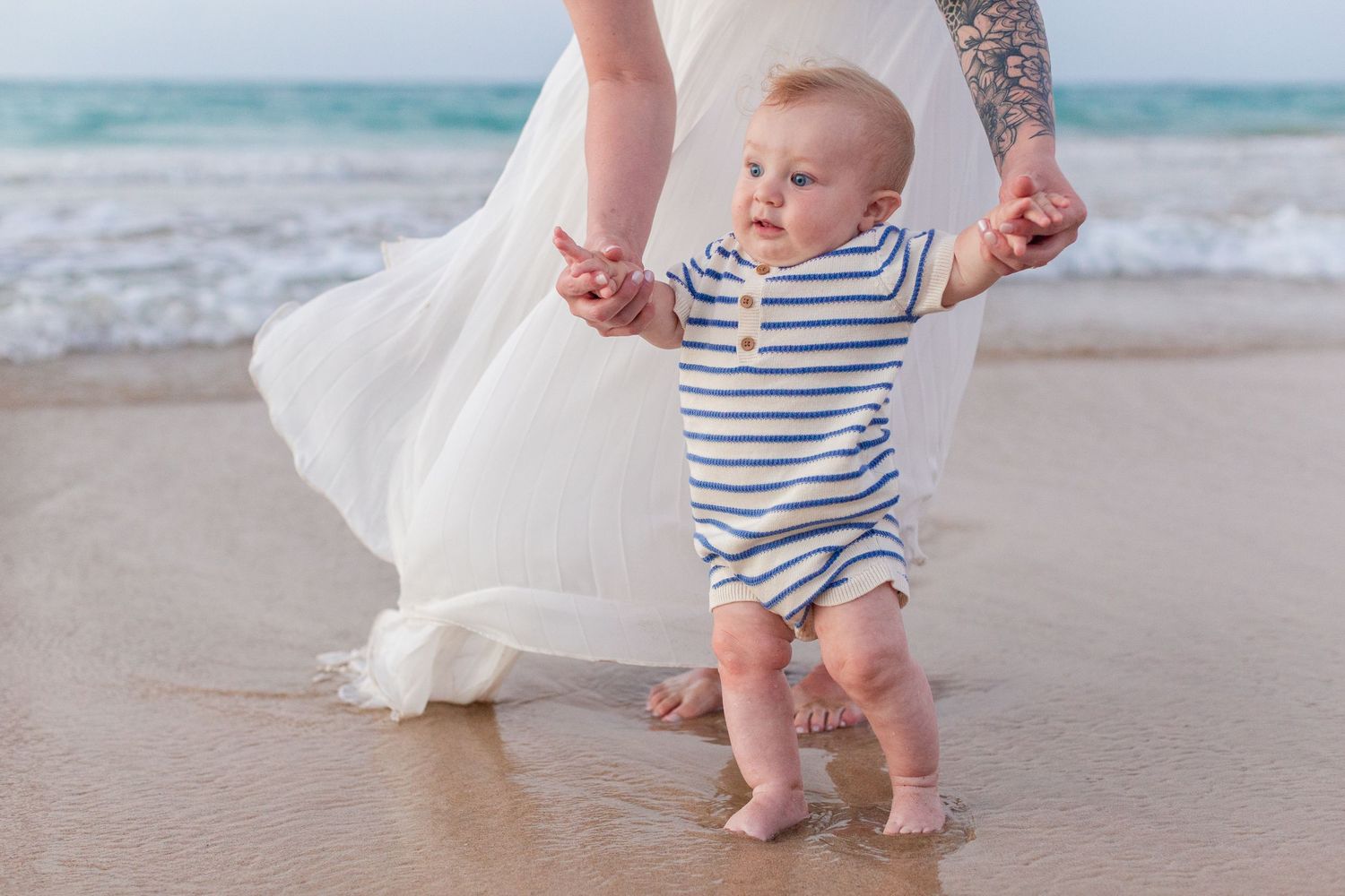 Family portrait on the beach in Isla Verde, Carolina, Puerto Rico. Mother and baby.
