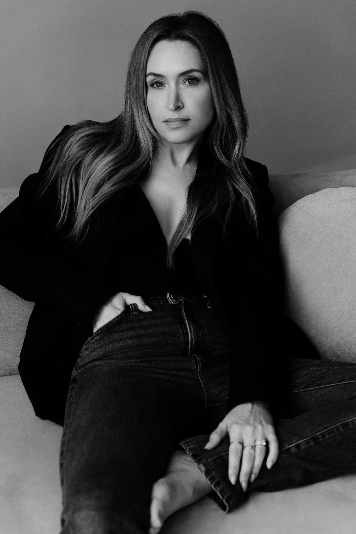 Female founder sitting on sofa in modern photo studio, Personal branding photography in Atlanta