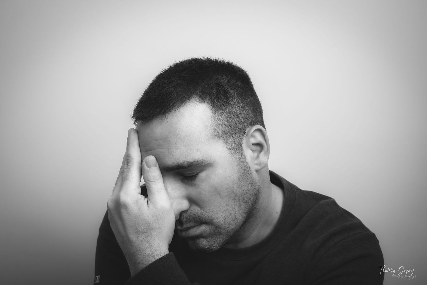 Black and white portrait series showing expressions of contemplation and distress.