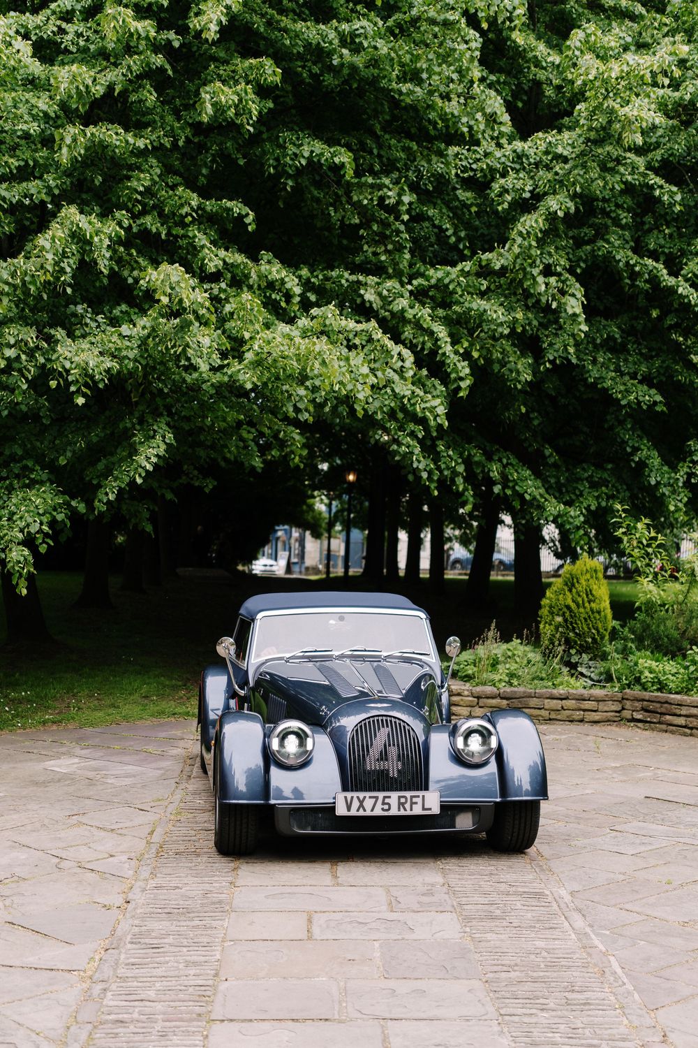 Vintage dark blue Morgan sports car for bride at St Mary Redcliffe Church, Bristol Wedding
